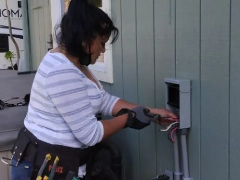 Licensed electrician wiring an exterior subpanel in Delaware